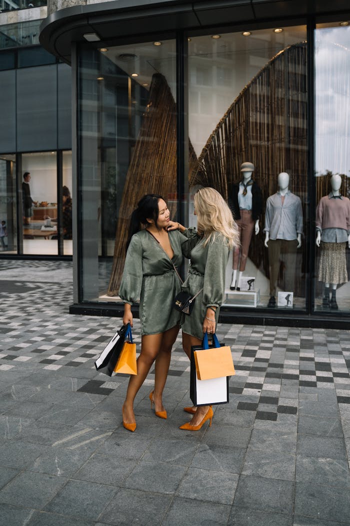 Two fashionable women with shopping bags enjoying a day out together.